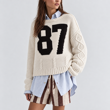 Skyler Varsity 87 Cable Knit Sweater in cream, three-quarter view