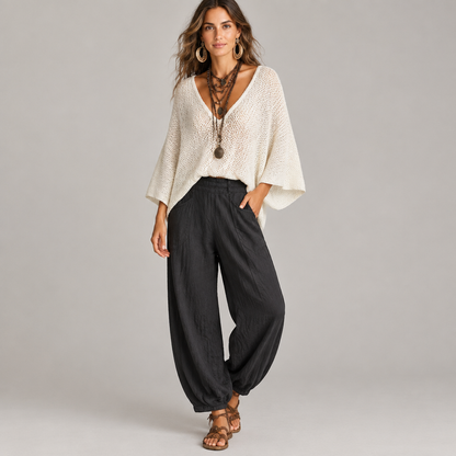 Woman wearing the cape sleeve sweater and harem pants set, front view