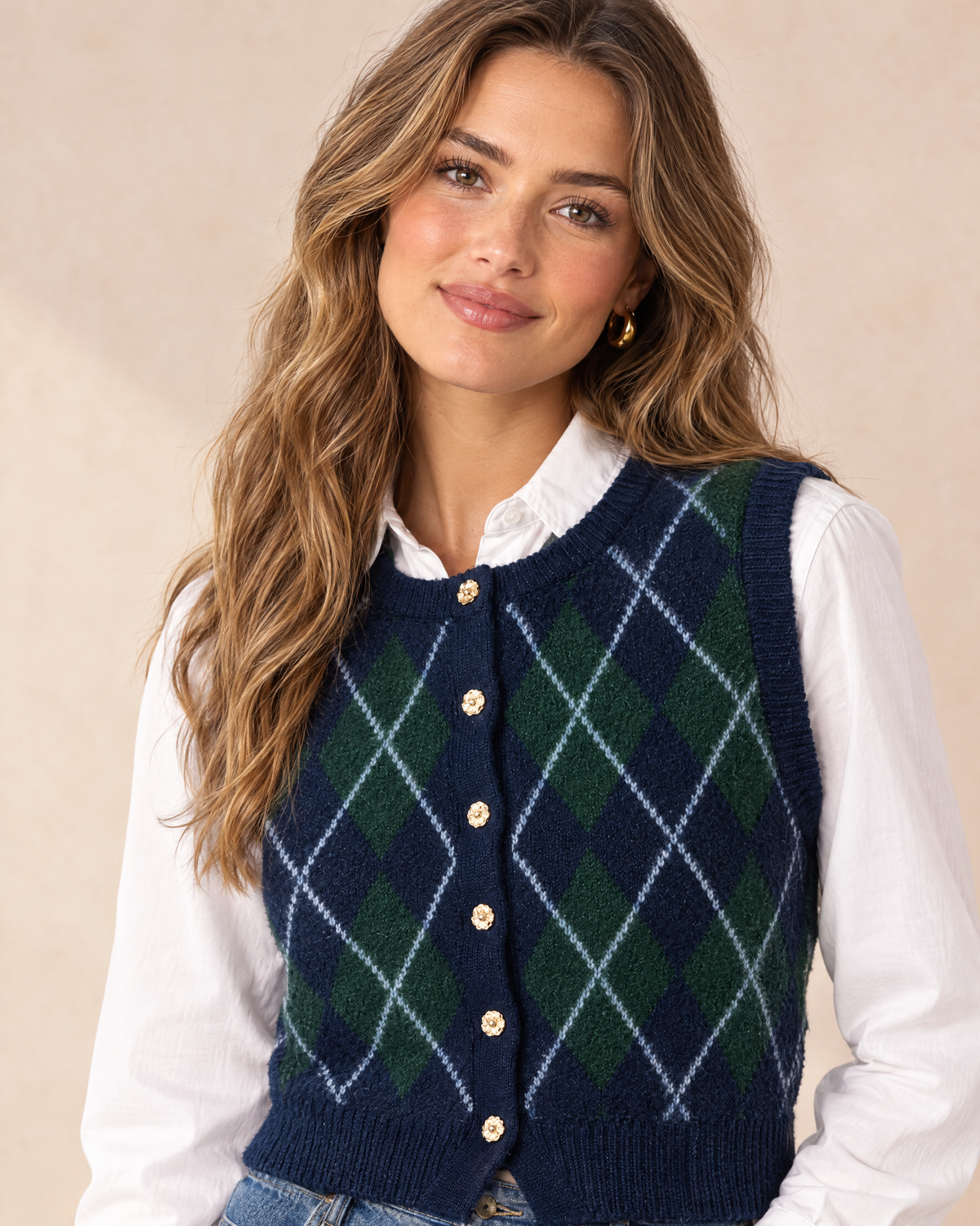 Argyle sweater vest worn by model, close-up of neckline and buttons