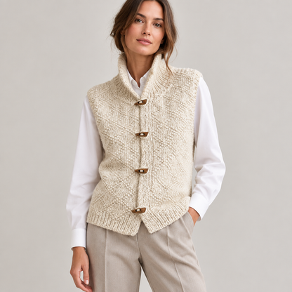 Woman wearing the sleeveless knit gilet over a white blouse, front view