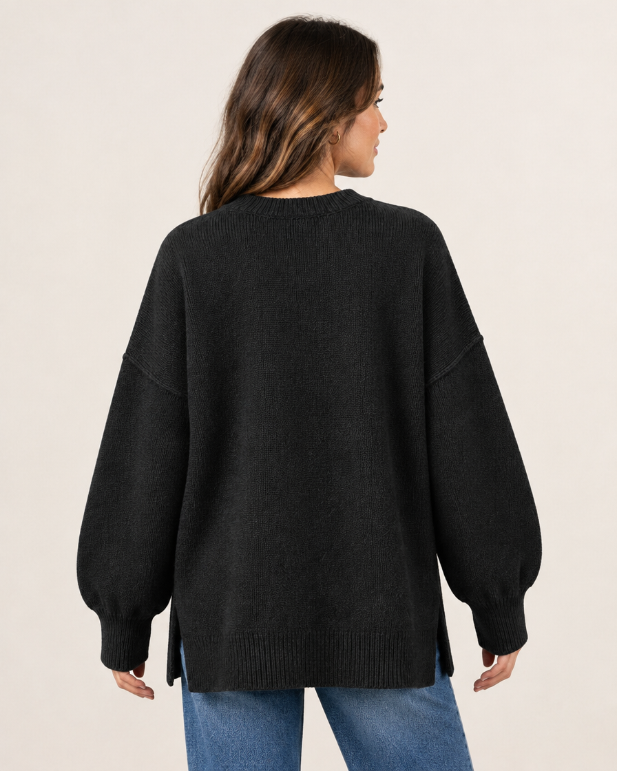 Model wearing black oversized knit pullover sweater, back view