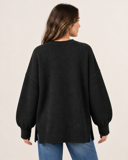 Model wearing black oversized knit pullover sweater, back view