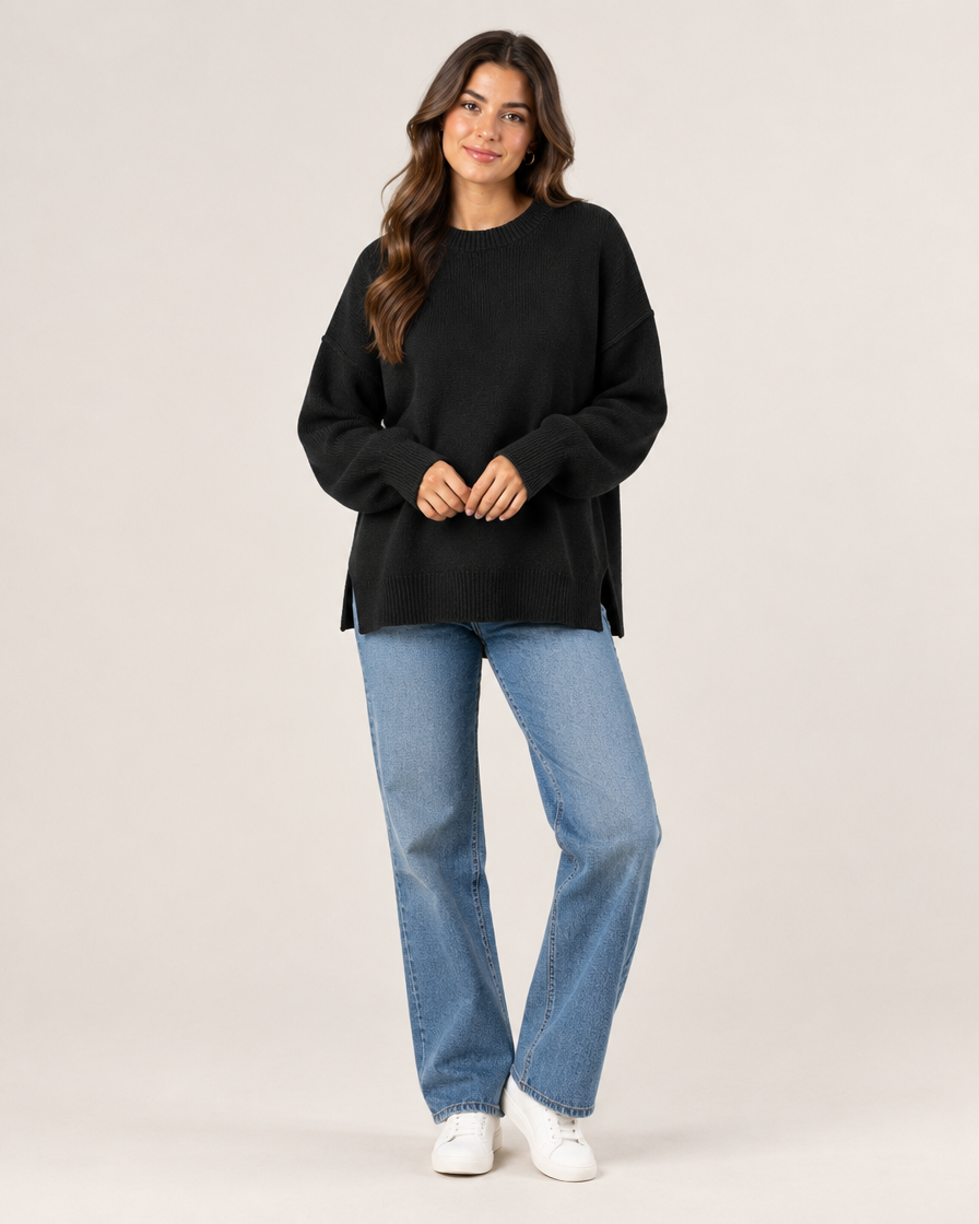 Model wearing black oversized knit pullover sweater, full body view