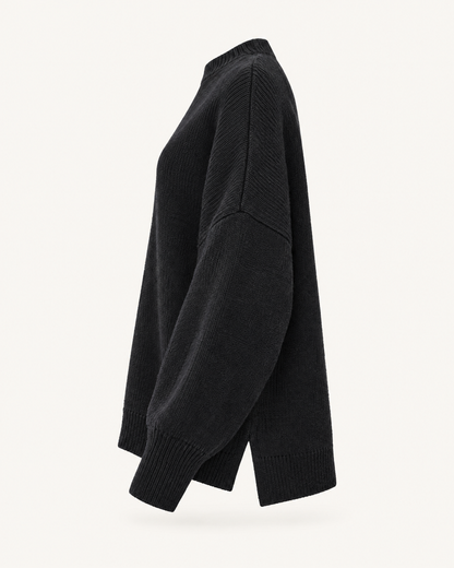 Black oversized knit pullover sweater, side view studio photo